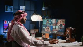 Arab man paying attention in private tutoring group webinar internet teleconference. Muslim student in online videocall with teacher and other diverse multiethnic colleagues, listening to lesson