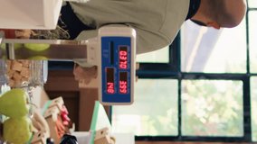Vertical video Seller shows freshly harvested apples to diverse couple in local zero waste eco shop, customers supporting organic farming for sustainable lifestyle. Storekeeper presenting ripe fresh - Powered by Shutterstock - Get 15% off with code: PIKWIZARD15
