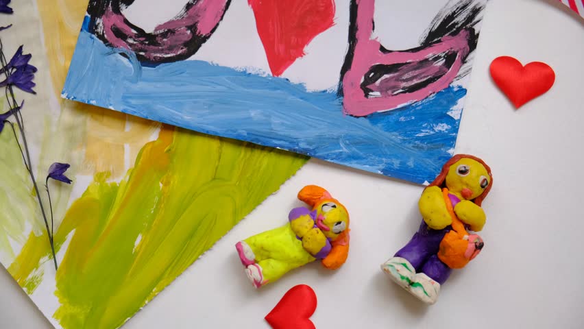 Child painting  couple swan, hearts, making crafts from paper. Handmade concept for birthday, mothers day or Valentines day. Education. Inspiration and imagination