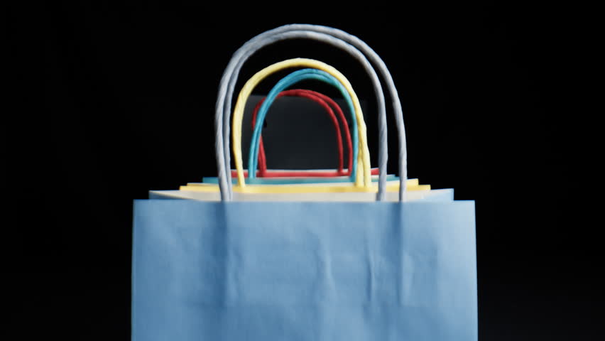 Passing through shopping bags and black Friday sign 
