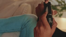 Vertical video, Close-up of young man's hands gamepads playing video game