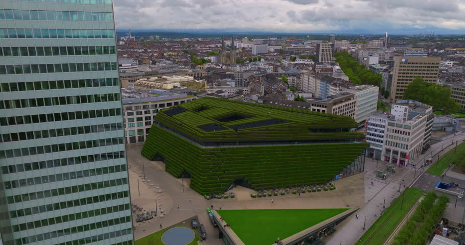 Establishing shot of the largest green facade in Europe, a green building envelope to improve the city climate. Business center in Dusseldorf. Modern and ecologic offices with many trees on balconies