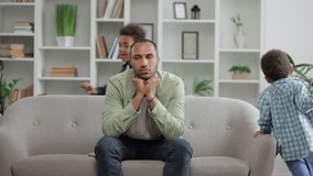 Irritated depressed caucasian man sad tired father feel stress headache due annoying active little child naughty boys disturb male parent babysitter. - Powered by Shutterstock - Get 15% off with code: PIKWIZARD15