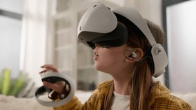 Surprised amazed Caucasian girl kid child schoolgirl playing online video game in 3D world metaverse using virtual reality helmet at home play gaming controller explore cyberspace wearing VR glasses - Powered by Shutterstock - Get 15% off with code: PIKWIZARD15