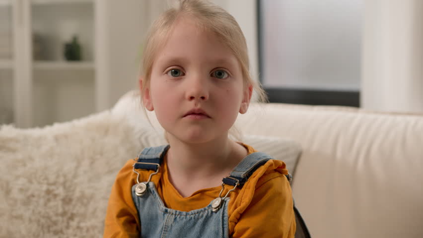 Close-up portrait little offended upset sad serious stressed worried caucasian preschool girl child female kid daughter looking camera at home alone sadness about abuse punishment for bad behavior Royalty-Free Stock Footage #1110664819