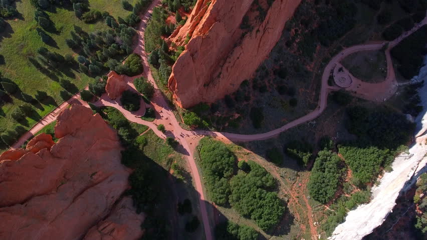 Aerial Forward Tilt Up Shot Of People Amidst Rock Formations Near Road Against Sky - Colorado Springs, Colorado