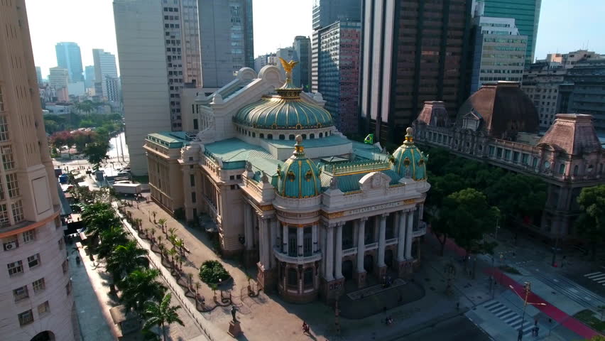 Aerial Forward Of Theatro Municipal With Flag Amidst Buildings In City - Rio de Janeiro, Brazil