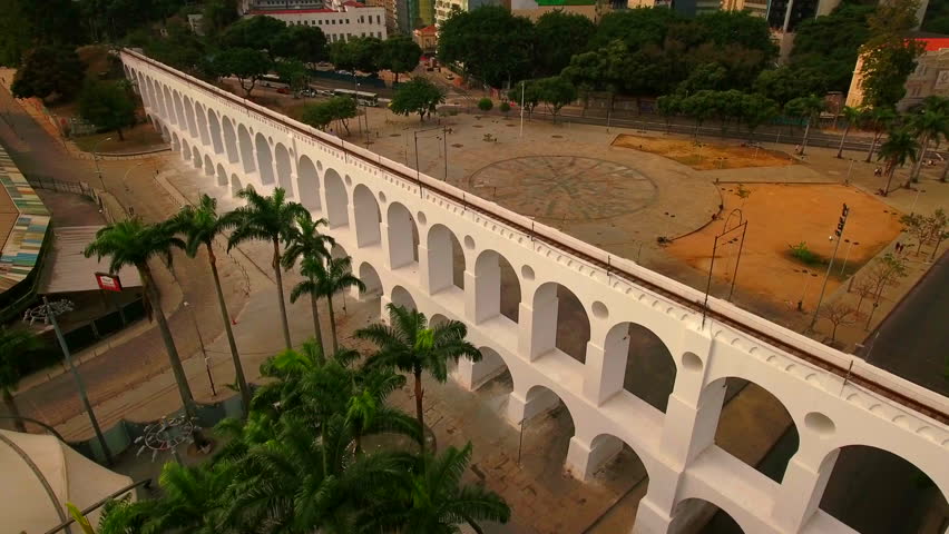 Aerial Forward Shot Of Carioca Aqueduct Near Streets And Buildings In City - Rio de Janeiro, Brazil Royalty-Free Stock Footage #1110668309
