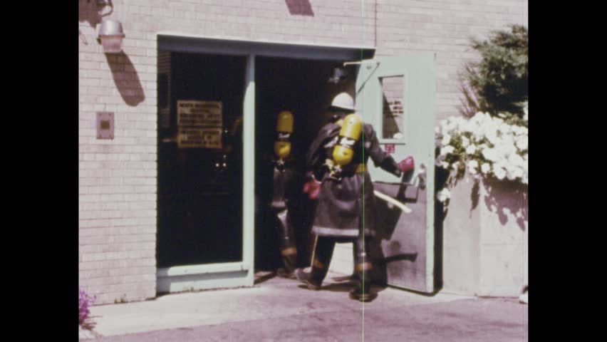 United States CIRCA 1960s: Fire cabinet valve turned. Water sprayed on garbage can fire. Nurse closing doors. Fire trucks speeding down the road. Firemen entering the hospital. Firetruck in the street