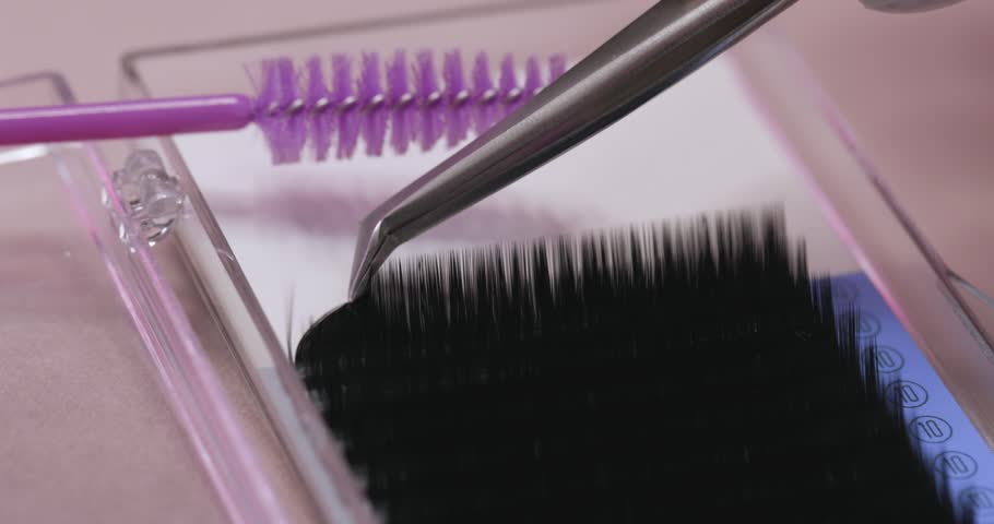 A lot of artificial eyelashes, tweezers and eyelashes. Professional eyelash extensions. | Shutterstock HD Video #1110681067