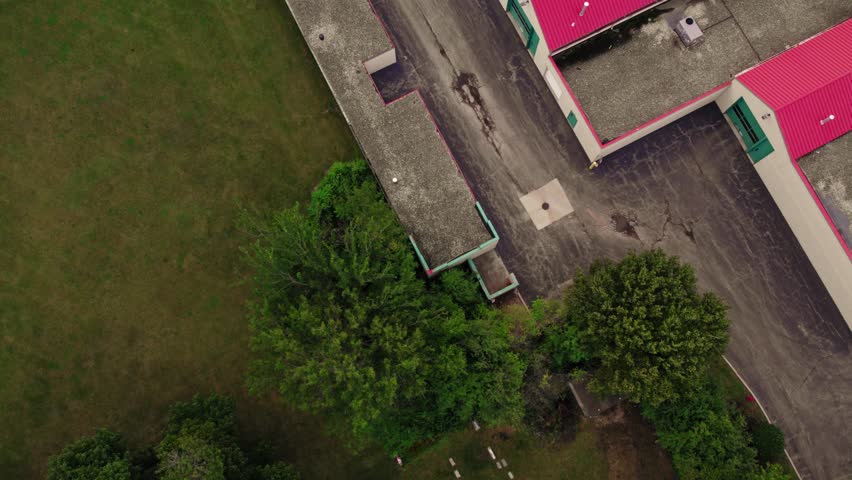 top down aerial revealing rental public storage with red roofing in America.