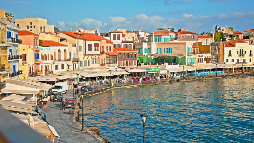 View of the colourful Old Venetian Port of Chania in Crete, Greece. Chania Harbour surrounded by turquoise-blue water, restaurants and colorful houses in Chania, Greece.