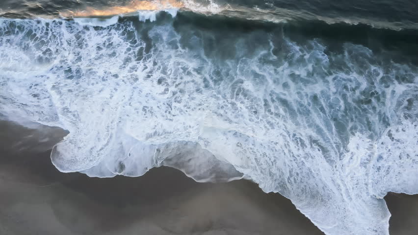 Aerial drone view over Atlantic ocean with beautiful waves pattern and sea foam. Landscapes view of endless aquamarine blue or turquoise sea or ocean water in summer day. Royalty-Free Stock Footage #1110693489