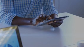 Animation of stock market data processing against african american man using a tablet at office. Global economy and business technology concept - Powered by Shutterstock - Get 15% off with code: PIKWIZARD15