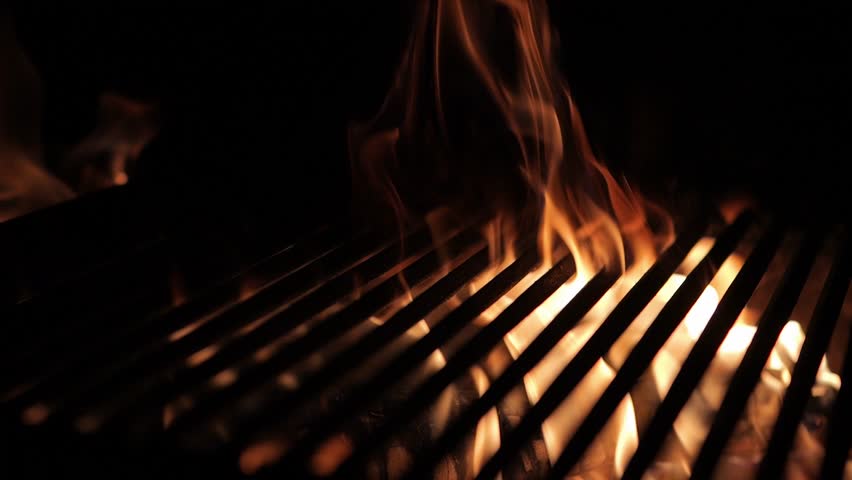 The fire burns through the grill grate. Hellish barbecue. Hearth in the fireplace. Royalty-Free Stock Footage #1110701077