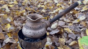 They prepare coffee in nature on a gas stove in a Turk, a real Turkish recipe for brewed coffee.