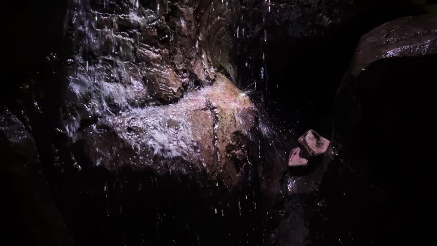 Waterfall on Dark Fountain Rocks at Night