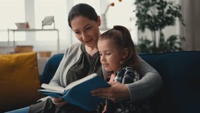 Happy mother reading a book with her cute little daughter, family relationship - Powered by Shutterstock - Get 15% off with code: PIKWIZARD15