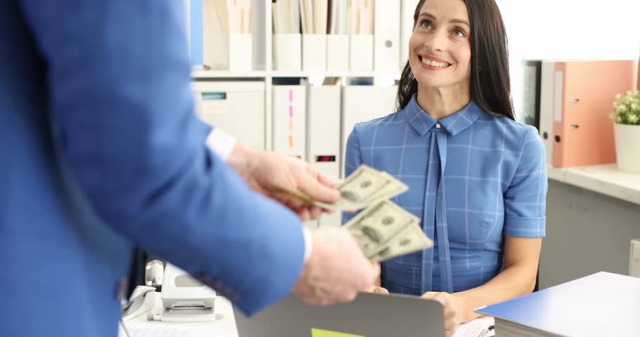 Male executive with counts cash and hands over to employee. Payment of wages in cash concept Royalty-Free Stock Footage #1110705963