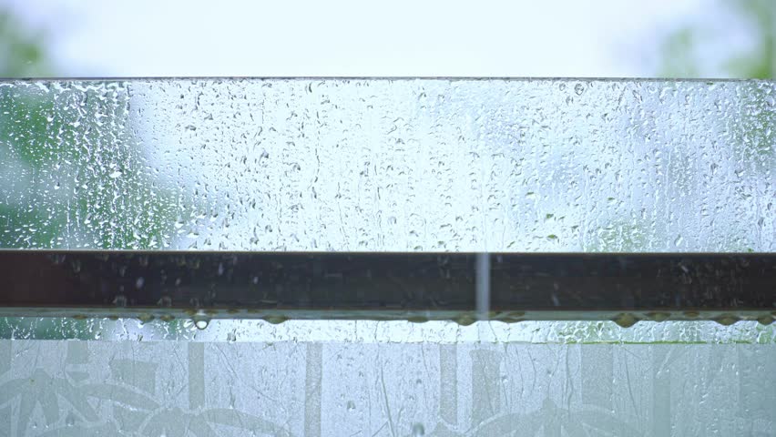 Rain drops on window glasses surface with blurred background . Natural Pattern of raindrops. selective focus | Shutterstock HD Video #1110708291