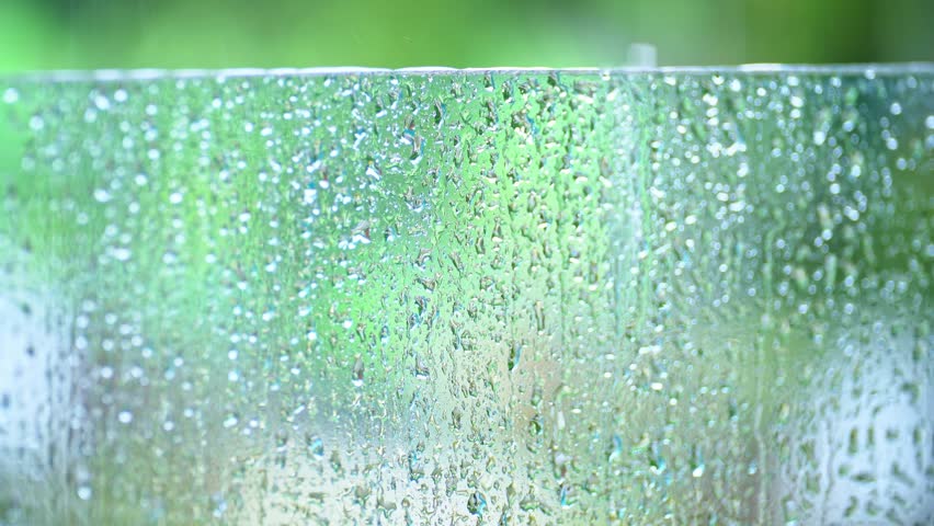 Rain drops on window glasses surface with blurred background . Natural Pattern of raindrops. selective focus | Shutterstock HD Video #1110708293