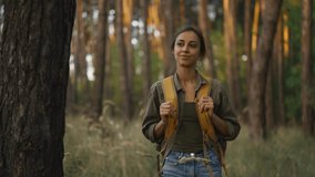 slow motion footage woman with yellow backpack Walks by trail in autumn forest. female hiker with backpack going up through wood with high grass. selective focus. traveling in Ukraine - Powered by Shutterstock - Get 15% off with code: PIKWIZARD15