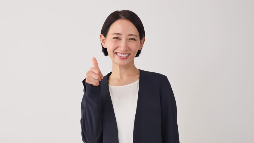 Asian middle aged businesswoman thumbs up gesture in white background Royalty-Free Stock Footage #1110714957