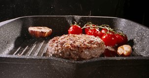 Sprig of rosemary is placed on fried vegetarian cutlets. Cinematic advertising plant-based imitation burger. Versatility of protein-packed vegetarian cutlets sizzling temptingly in hot frying pan