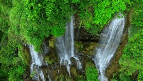 Enchanting Aerial View: Explore the mystical magic waterfall tucked away in a lush, emerald tropical rainforest. A hidden gem waiting to be discovered. Tropics' green oasis. Thailand.
