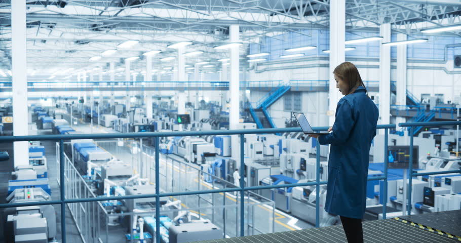 Experienced Female Engineer Standing on a Platform, Using Laptop Computer and Overlooking Production at a Modern Automated Electronics Manufacture with AI Support. Factory Manager at Work Royalty-Free Stock Footage #1110718971