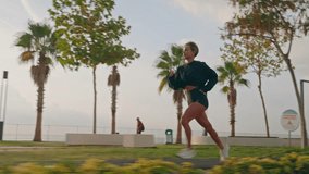Tracking shot of Young fitness sports woman running outdoors on the promenade during sunset. High quality 4k footage - Powered by Shutterstock - Get 15% off with code: PIKWIZARD15
