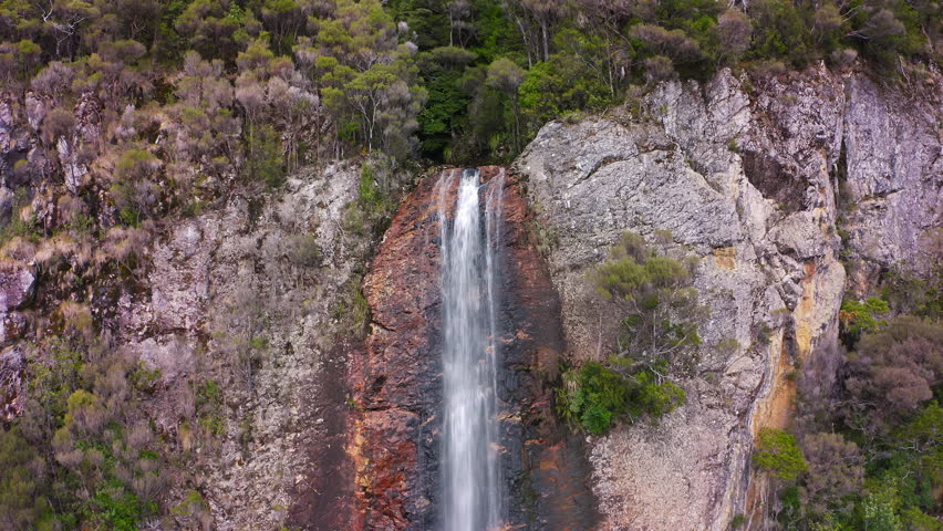 Mountain cliff waterfall aerial view. Tasmania Montezuma falls scenic landscape Royalty-Free Stock Footage #1110723911