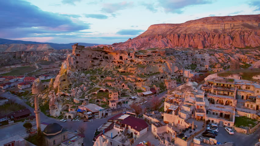 A town with a mosque in a cappadocia at dawn.Drone shot 4k