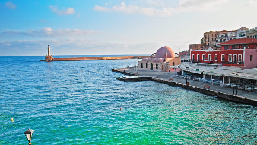 View of the colourful Old Venetian Port of Chania in Crete, Greece. Kucuk Hasan Mosque domed, a prominent landmark on Chania