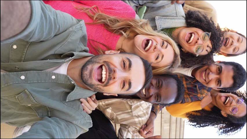 Multiracial friends taking selfie video with smart mobile phone outside - Happy young people laughing together at camera - Youth community concept with guys and girls hanging out on sunny day