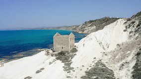 Drone view in Punta Bianca, abandoned stone house on white cliffs in Sicily, aerial video in Agrigento. 