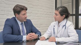 Female Doctor Talking with Middle Aged Man