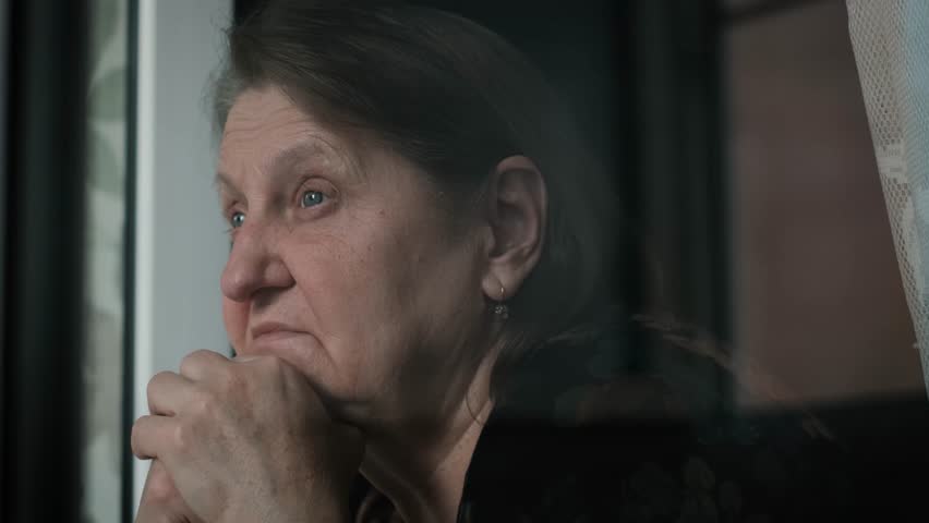 Sad elderly lonely woman looking out the window, close up Royalty-Free Stock Footage #1110737633