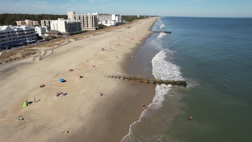 Rehoboth beach delaware drone descending spiral over swimmers in Atlantic Ocean 