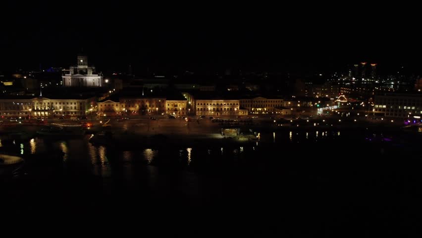 Low waterfront aerial: Helsinki City Hall waterfront on black night