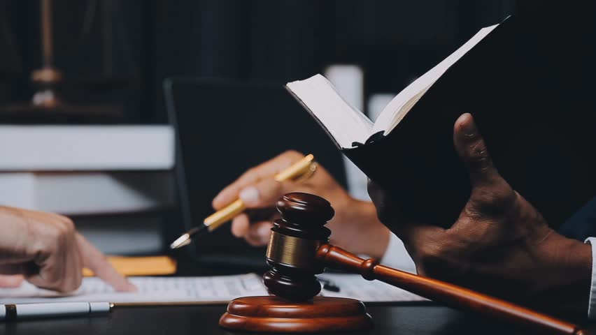 A Legal Perspective, Business and Legal Professionals Deliberate Contract Papers with Precision Using a Brass Scale - Depicting Law, Legal Services, Advice, and Justice with Film Grain Effect Royalty-Free Stock Footage #1110754765