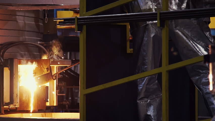 The process of casting the molten metal at the modern production facility. Molten metal is used for the production of steel items. Molten metal is poured into the form at the production factory. | Shutterstock HD Video #1110754877