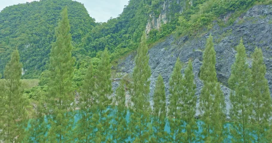 
Aerial view Pine trees line the side of an emerald green pond.Aerial view beautiful The reflection of the blue sky in the emerald green pond.
Emerald green pond at an old mine.

blue water blue sky b