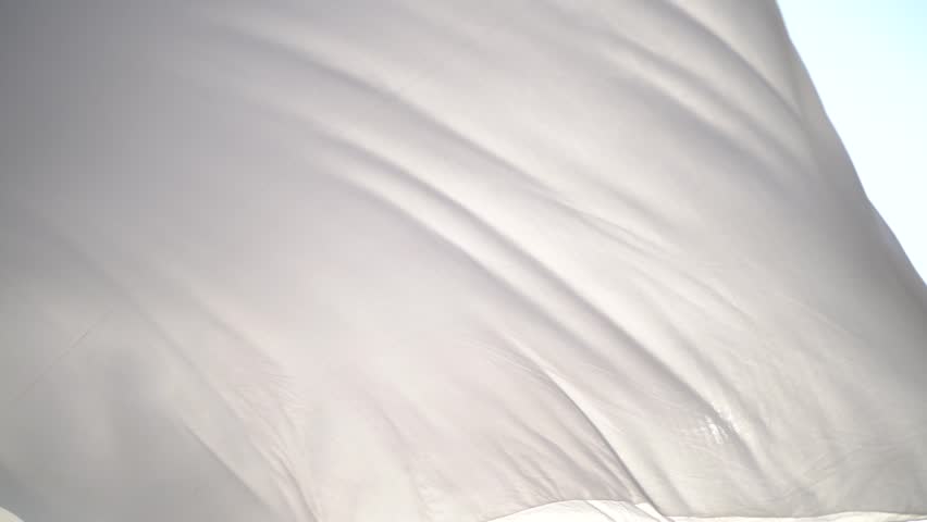 Background of white wave satin fabric loop.Silken cloth flowing in the wind. Royalty-Free Stock Footage #1110757647