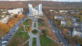 Panoramic aerial drone view of Afghan War Memorial To Sons of Motherland - Eternal Memory at autumn season. Multiple residential buildings, cars riding on background. Chisinau, Moldova. 4K video