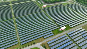 Solar array harmoniously integrated into the landscape, seen from above, blending green fields with renewable technology. Harnessing Earth's vitality: Renewable Energy.
