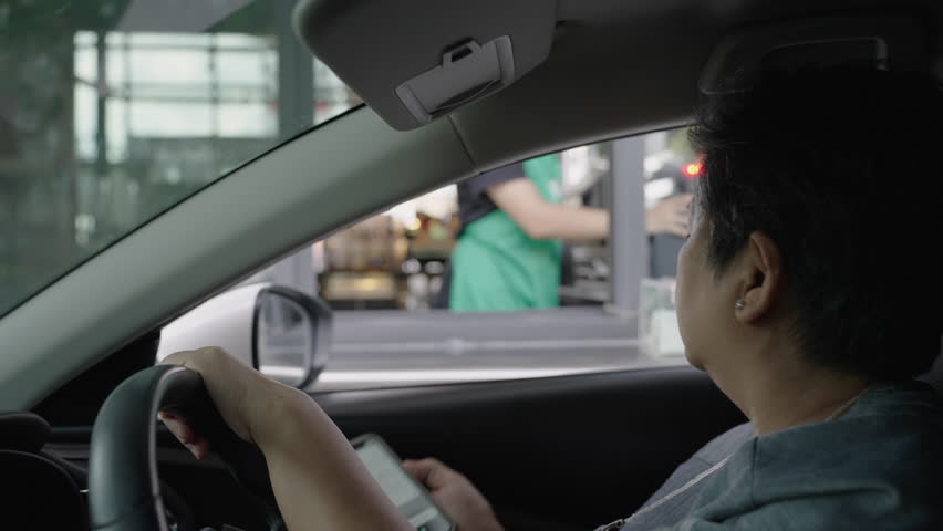 Contactless payment, Digital Wallet, Digital Money, Asian senior, old, retired, woman pay for take out food or drinks via smartphone by driving through or drive thru. Royalty-Free Stock Footage #1110768815