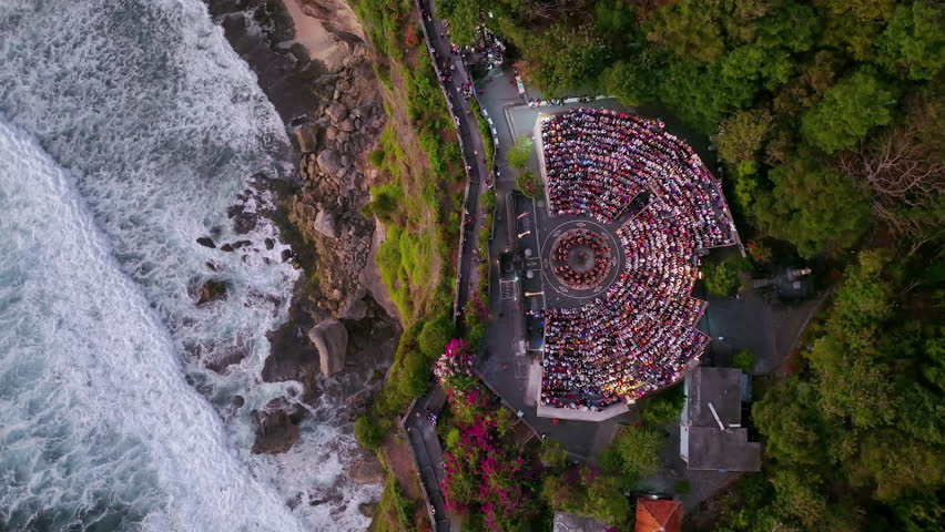 Tourists Audience Watch of Traditional Balinese Kecak Dance at Uluwatu Temple, Bali, Indonesia.