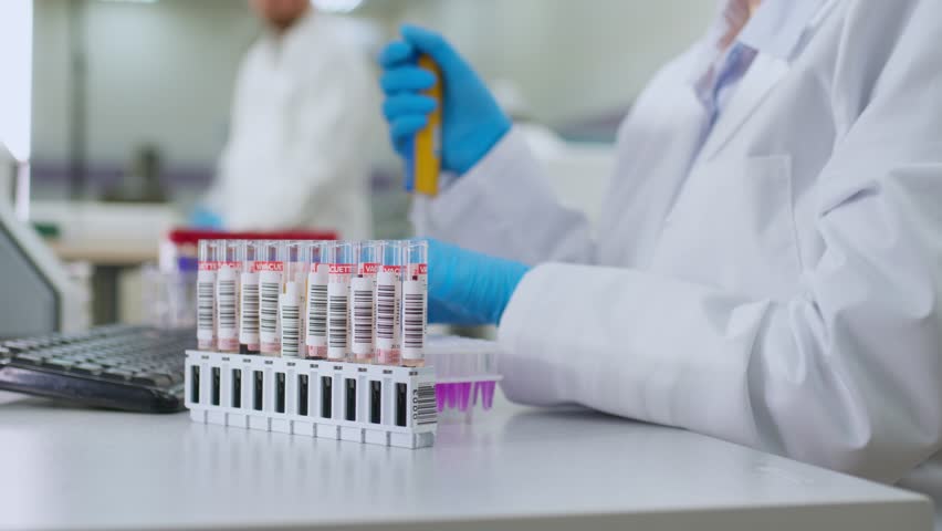 A team of scientists working and analyzing trial data for new generation drugs. They work in a modern laboratory-medical center. Royalty-Free Stock Footage #1110774419