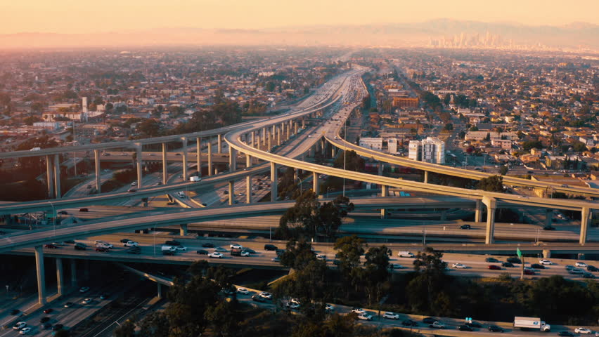 AERIAL: Spectacular Turning Overhead Shot of Judge Pregerson Highway showing multiple Roads. cars driving by multi-level highway in Los Angeles, California USA. Direct view from above to road traffic. Royalty-Free Stock Footage #1110778247